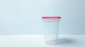 Clear Urine collection container with secure red cap. Medical specimen cup for testing. Concept of diagnostic procedures