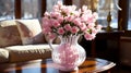 clear vase full of pink roses sits on a wooden table in a sunny room with lamp, giving a feeling of warmth and comfort