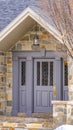Clear Vertical Facade of a home with a beautiful stone wall and gray front door