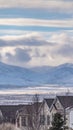 Clear Vertical Striking mountain blanketed with snow under a cloudy blue sky in winter