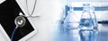 Clear water in flask with stethoscope and computer tablet medical science lab banner background