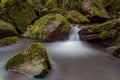 Clear water flowing through a rocky river in a forest Royalty Free Stock Photo