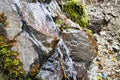 clear water from a mountain spring flowing over the rocks Royalty Free Stock Photo