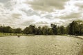 Clear water pond in a park and tress background