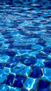 Clear water ripples over blue tiles, forming a mesmerizing abstract