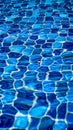 Clear water ripples over blue tiles, forming a mesmerizing abstract