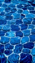 Clear water ripples over blue tiles, forming a mesmerizing abstract