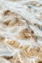 Clear water ripples over sandy seabed with sunlight creating patterns, showing natural ocean movement and light refraction. Royalty Free Stock Photo