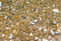 through clear water, small colored stones are visible