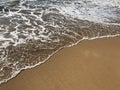 Clear water and soft sand meeting at the coastline