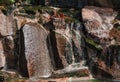 Water in sunlight flowing over the natural rocks