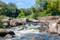 Beautiful stone rapids on the path of a small forest stream on a sunny summer day Royalty Free Stock Photo