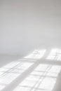 Clear white cyclorama. Light background with sun light and shadows. Plain wall empty photo studio. Royalty Free Stock Photo