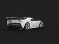 Clear white modern luxury super car on dark background - back view Royalty Free Stock Photo