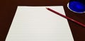 Clear White note paper with red pencil and blue glass on dark brown table. Business concept Royalty Free Stock Photo