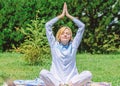 Clear your mind. Girl meditate on rug green grass meadow nature background. Woman relaxing practicing meditation. Every Royalty Free Stock Photo