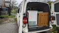 Clearing furniture from a farmhouse in the back of a white van truck Royalty Free Stock Photo