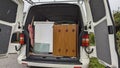 Clearing furniture in the rain into the back of a white van