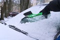 removing snow from the car windshield, scraping ice Royalty Free Stock Photo