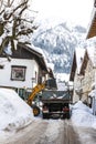 Clearing a road from thick layers of snow inwinter in Bavaria, Germany Royalty Free Stock Photo