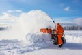 Clearing snow from the highway using specialized machinery following a snowstorm