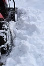 Clearing snow plow garden tractor, rear view.