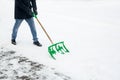 Clearing snow from the road with a shovel