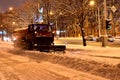 Clearing the streets of snow after a snowfall. Front view of snowplow service truck and gritter spreading salt on the road surface