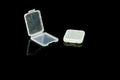 Clearly plastic box for memory card on the black background reflector Royalty Free Stock Photo