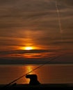 Cleat, and fishing rod at sunset Royalty Free Stock Photo