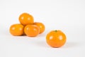 Clementine Separated from Small Pile on White Royalty Free Stock Photo