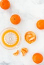 Clementines and Citrus Glass Juicer on White Marble Background Royalty Free Stock Photo