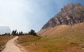 CLEMENTS MOUNTAIN TOWERING ABOVE HIDDEN LAKE HIKING TRAIL ON LOGAN PASS DURING 2017 FALL FIRES IN GLACIER NATIONAL PARK MONTANA US Royalty Free Stock Photo