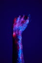 clenched fist hand closeup on dark blue background conceptual studio