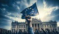 Clenched fist raised in front of the European Union flag, symbolizing solidarity, strength, unity, and the fight for Royalty Free Stock Photo