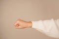 A clenched fist symbolizes strength, resistance, or determination. The bold gesture conveys a powerful message of unity