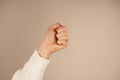 A clenched fist symbolizes strength, resistance, or determination. The bold gesture conveys a powerful message of unity
