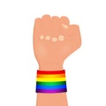 Clenched fist wearing rainbow colored lgbt wristband