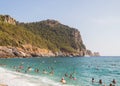 Cleopatra beach in Alanya. People swim in the mediterranean sea overlooking the mountains.