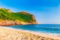 Cleopatra beach on sea coast with green rocks in Alanya peninsula, Antalya district, Turkey. Beautiful sunny landscape for tourism Royalty Free Stock Photo