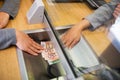 Clerk giving cash money to customer at bank office Royalty Free Stock Photo