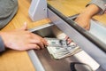 Clerk giving cash money to customer at bank office Royalty Free Stock Photo