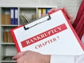 Clerk holds bankruptcy chapter 7 documents about insolvency.