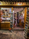 Clerk puts away merchandise at Montmartre tourist shop in Paris, France Royalty Free Stock Photo