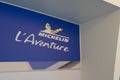 Michelin l`aventure bibendum logo blue sign and text front of entrance of