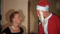 CLEVELAND, OHIO 1953: Creepiest Santa Claus mask ever giving gifts to family.