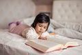 Clever baby girl staring at book Royalty Free Stock Photo