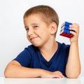 Clever boy. The child solved the problem. He collected a Rubik`s Cube Royalty Free Stock Photo