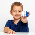 Clever boy. The child solved the problem. He collected a Rubik`s Cube Royalty Free Stock Photo
