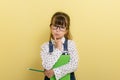 Clever child in eyeglasses holding draw and paint supplies. Kids happy to go back to school. Royalty Free Stock Photo